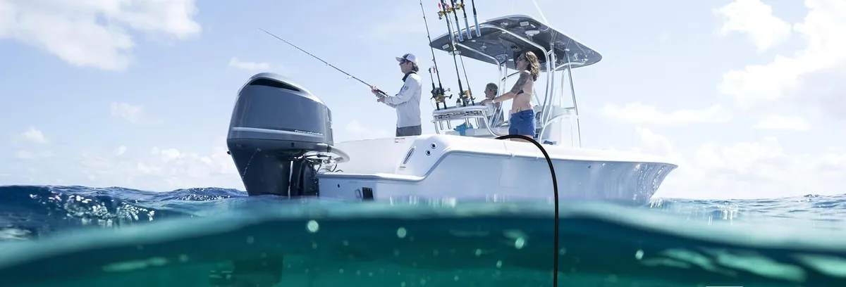 Anglers on a centre-console boat above green-lit water