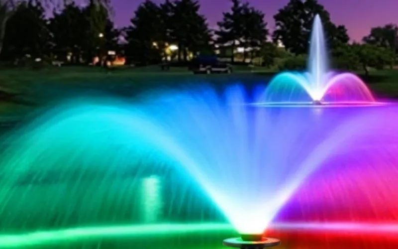 A fountain spray glowing green and red above the Goldlife F0 light ring
