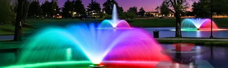 A pond fountain lit from below by the Goldlife F0 light ring at night