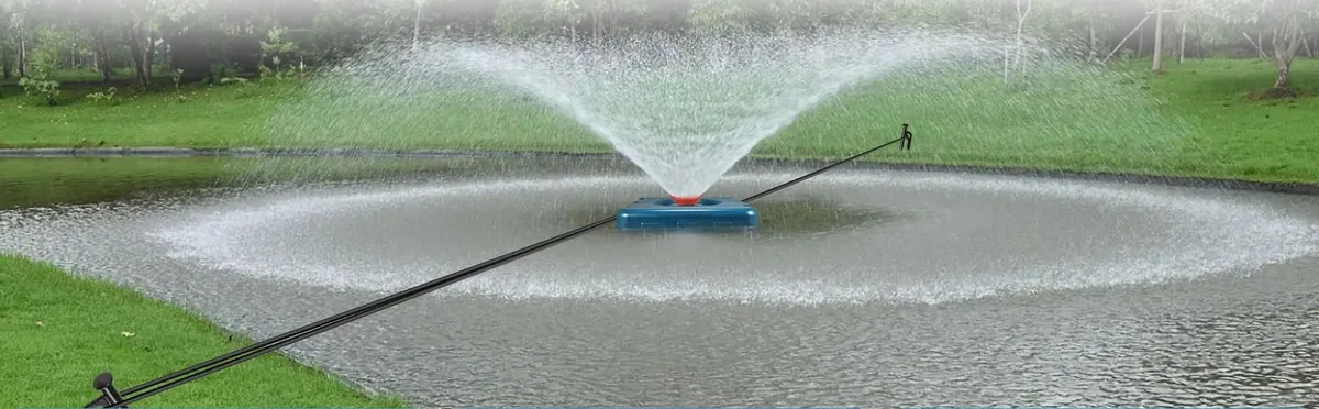 The Goldlife F2 floating fountain throwing a wide spray on a pond in daylight