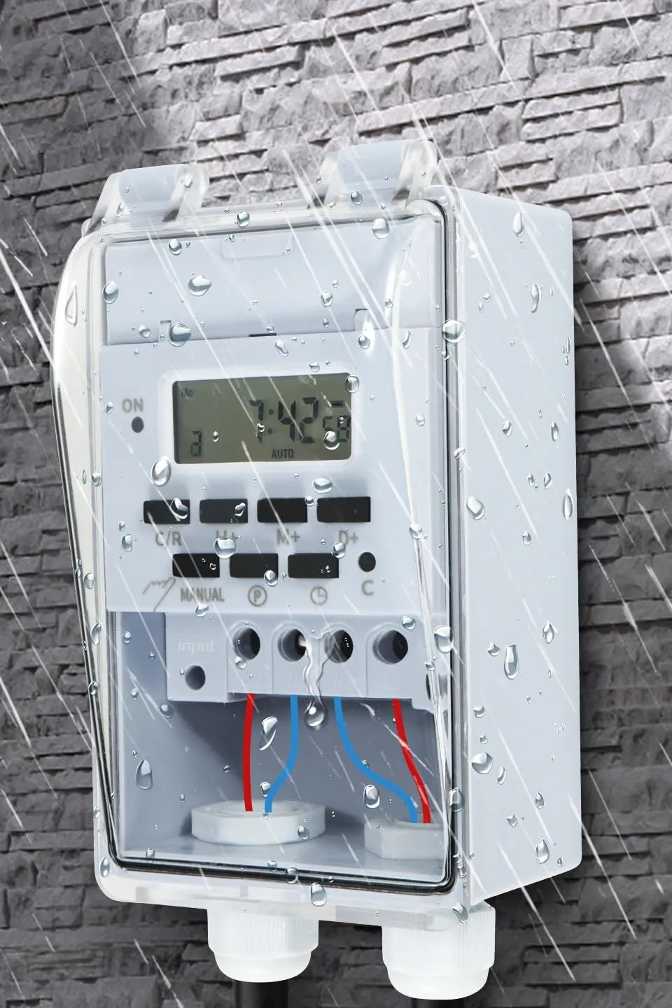 The Goldlife outdoor timer switch mounted on a stone wall in the rain
